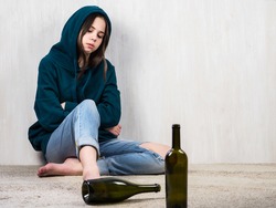 Alcohol abuse. Psychology. Depressed and intimidated teenage girl against alcohol. The concept of alcohol addiction among adolescents. Family aggression.