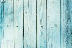 Turquoise bright colored old vintage wood with vertical boards. Grunge wooden background. Shabby chic France Provence style. Green blue sea color