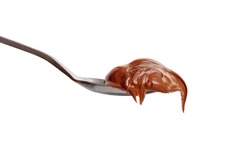 Chocolate paste in a spoon isolated on white background. Sweet sauce. Сhocolate butter.
