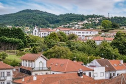 Roofs of buildings in Caminha overlooking the Church and convent of Santo António with the mountain in the background, PORTUGAL