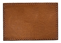 Blank brown leather label on white background, macro close up. Leather patch with stitching