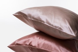 Two silk pillows on white background, soft luxury cushion 