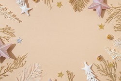 Festive Christmas and New Year backround with golden white holiday decoration on pastel beige with copy space. Top view. Merry Christmas monochrome concept.