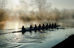 Team rowing on a mirror
