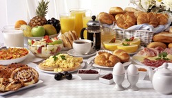 BREAKFAST BUFFET TABLE FILLED WITH ASSORTED FOODS,SAVOURY,SWEET,PASTRIES,HOT AND COLD DRINKS