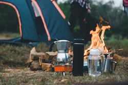 Manual equipment coffee set with bonfire in camping of people camper group in nature near the mountains, Tourism Camping Trip, Outdoor Adventure of Hiking.