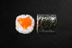 Maki with salmon on a black background