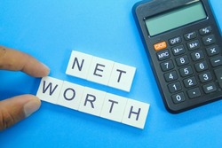 calculator and the word net worth. computational management concept