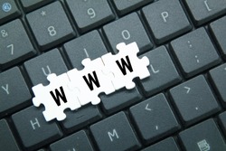 laptop keyboards and puzzles with the letters www. website concept