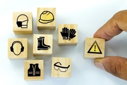 wooden cubes with safety icons under construction. Safety First Construction Concept
