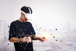 Businessman use vr glasses and looks at building background, studio shot.Virtual gadgets for entertainment, work, free time and study. game cyber Virtual reality technology concept.