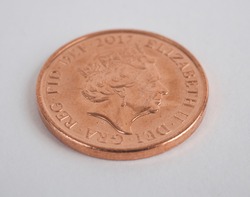 A studio photo of an English penny coin