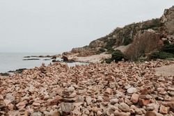 Balancing stones on the rocky coast at Hovs Hallar nature reserve in Sweden.