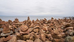 Balancing stones on the rocky coast at Hovs Hallar nature reserve in Sweden.