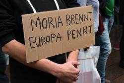 Cardboard with German text Moria brennt, Europa pennt (Moria is burning, Europe is sleeping) on a demonstration in Lubeck for accommodation of refugees after the fire in the Greek refugees camp 