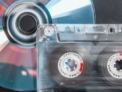 A cassette tape and a compact disc ( CD ). Music storage concept.