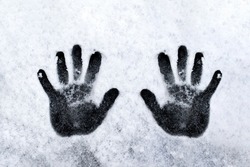 Hand prints on wall, black and white. High quality photo