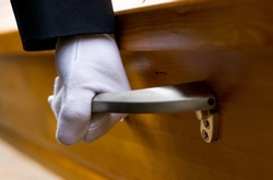 a hand on a coffin