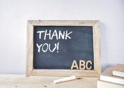 THANK YOU note on chalkboard with 3d wooden alphabet letters at the corner. Teacher's day celebration concept. 