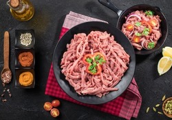 raw meat styled in black with vegetables