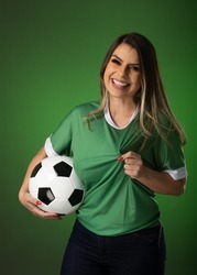 woman soccer fan cheering for her favorite club and team. world cup green background.