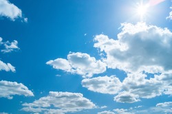 beautiful blue sky with clouds and sun