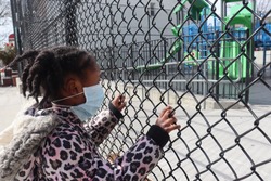 Little Girl wearing Surgical Mask on Playground