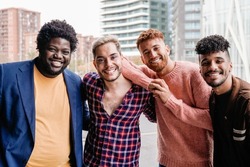 Diverse trendy group of friends having fun outdoor - Diversity and multiracial people - Focus on non-binary gay man