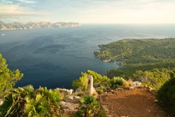A great hiking trail with ruins of a old bunker. beautiful panoramic view of the cliffs and the coastline during sunrise. turquoise blue water. Spanish island of Mallorca (Majorca).