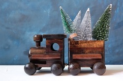 Christmas background. Christmas tree on wooden toy train. New year or Christmas decorations concept.