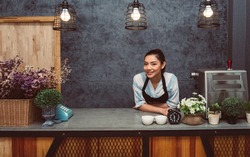 Portrait of happy young women coffee shop owner 