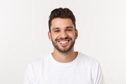 Portrait of a handsome young man smiling against yellow background