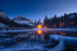 Warm light in cold Canadian winter. Emerald Lake is located in Yoho National Park, British Columbia, Canada. The high-end lodge perched on the edge of the lake, provides local accommodation.