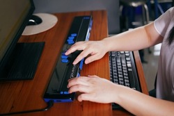Person with blindness hands using computer with braille display or braille terminal a technology assistive device for persons with visual impairment.