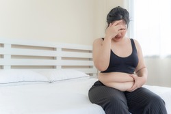 asian fat women , Fat girl , Chubby, overweight unhappy measuring her waist in the bedroom - Woman diet lifestyle overweight problem concept