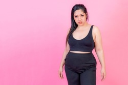 Portrait asian fat women , Fat girl , Chubby, overweight squeeze belly fat , young woman isolated on pink background , plus size fashion model body positive concept