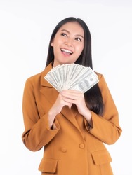 Successful beautiful Asian business young woman holding money US dollar bills in hand isolated on white background with copy space , business concept