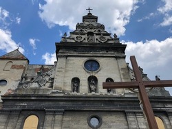 Macro photo old Lviv Catholic church. Stock photo old Ukrainian church building with cross