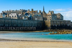 Saint-Malo, Brittany, France: View of the historic fortified part of town (Intra-Muros) from the Sillon beach on a sunny morning at low tide. 