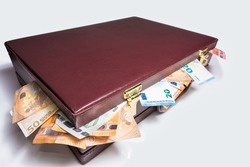Closed 24 hour briefcase with euro banknotes coming out