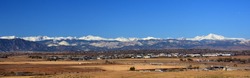 looking out  at boulder's flat irons, long's peak,  rock creek open space, and the  front range of colorado's rocky mountains from broomfield, colorado, on a sunny day in early winter