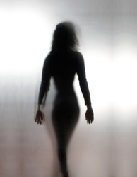 Silhouette woman walking away