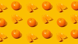 Fresh citrus Seamles fine pattern. Ripe fruit tangerines. Trendy sunlight Summer pattern made with mandarine slice on bright light orange background. Minimal summer concept. Monochromatic Banner.