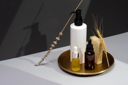 Set of essential oils, handmade soap and dried lavender on a dark gray background. Creative still life with natural cosmetics. The concept of selfcare and organic products. Isometric projection.