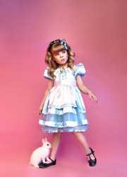 Pretty little girl with rabbit, Alice in wonderland, cute child 