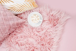 Stylish pink pillows and cup of coffee. Copy space. Flat lay, top view