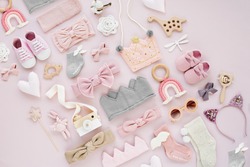 Set of  baby girl accessories on pink background. Various head band and hair bow, toy, little shoes, socks. Fashion kids stuff and accessories. Flat lay, top view