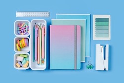 Notebooks and stylish school stationery is arranged in organizers. Creative Drawer Organizing. Storage office supplies. Concept back to school. 