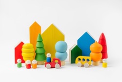 Colorful  wooden toys. Houses, trees, toy cars and little men in the colors of the rainbow. Cute kids toys to play and for decorating children's room. Wooden play set. 