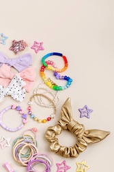 Set of baby girl hair accessories. Fashion hair bows, hair clips, hairpins and hair elastics.  Hairstyles for girls with stylish accessory. 